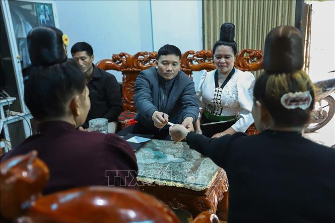 Thành viên Tổ bầu cử tại khu vực bỏ phiếu số 02, đơn vị bầu cử số 01, bản Thống Nhất, xã Mường Sại (Sơn La) phát thẻ cho cử tri. Ảnh: Trọng Đạt - TTXVN