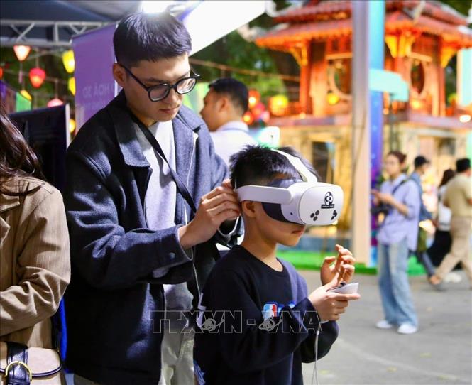 Các bạn nhỏ hào hứng tham gia hoạt động tương tác công nghệ tại khu trải nghiệm thực tế ảo. Ảnh: Lan Anh/TTXVN phát