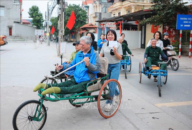 Các thương binh đang điều dưỡng tại Trung tâm Điều dưỡng thương binh Thuận Thành di chuyển đến điểm bỏ phiếu. Ảnh: Hoàng Hiếu - TTXVN