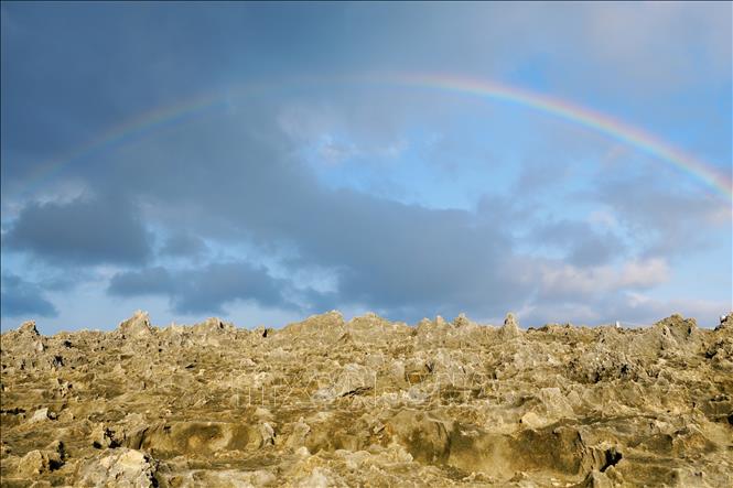 Rainbow over the fossilised coral terrace in Hang Rai. VNA Photo: Nguyễn Thành