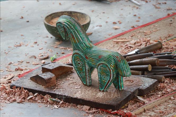 Each piece of artwork made from firewood is unique. VNA Photo