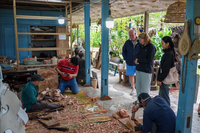 Foreign tourists visit the Cui Lu village. VNA Photo