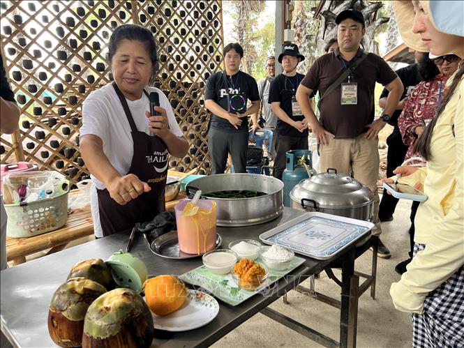 Người dân địa phương giới thiệu cách làm món bánh tráng miệng làm từ bột nếp và dịch quả thốt nốt. Ảnh: Đỗ Sinh – PV TTXVN tại Thái Lan 