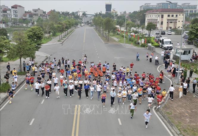 Đại biểu, VĐV tham gia chạy hưởng ứng. Ảnh: Minh Quyết - TTXVN