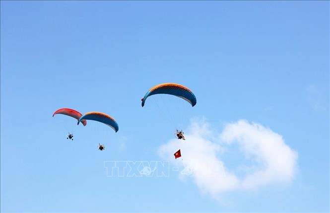 Các phi công dù lượn bay trình diễn trên bầu trời xã Tri Tôn, tỉnh An Giang. Ảnh: Công Mạo-TTXVN