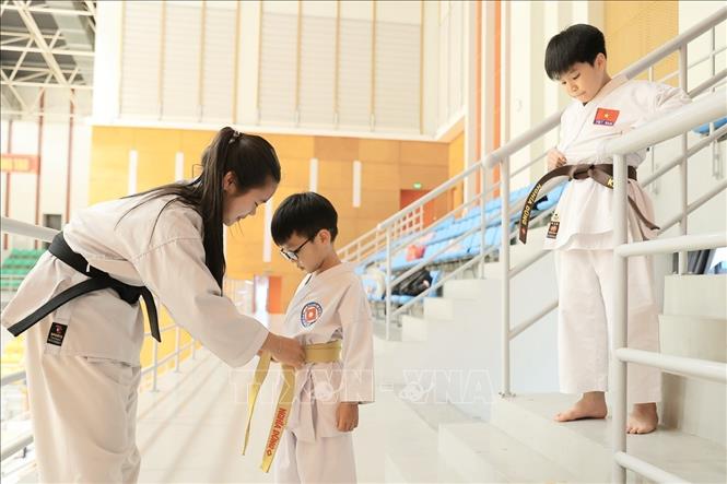 Võ sinh chuẩn bị trang phục cho buổi tập. Ảnh: Minh Quyết - TTXVN