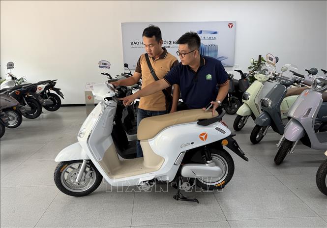 Anh Nguyễn Tấn Kiệt tìm hiểu về xe máy điện tại Cửa hàng Yadea Cái Răng, đường Võ Nguyên Giáp, phường Hưng Phú, thành phố Cần Thơ. Ảnh: Nguyễn Văn Việt -TTXVN