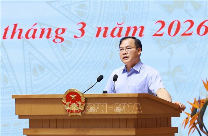 Thứ trưởng Bộ Công an Nguyễn Văn Long báo cáo kết quả triển khai Đề án 06. Ảnh: Dương Giang-TTXVN 
