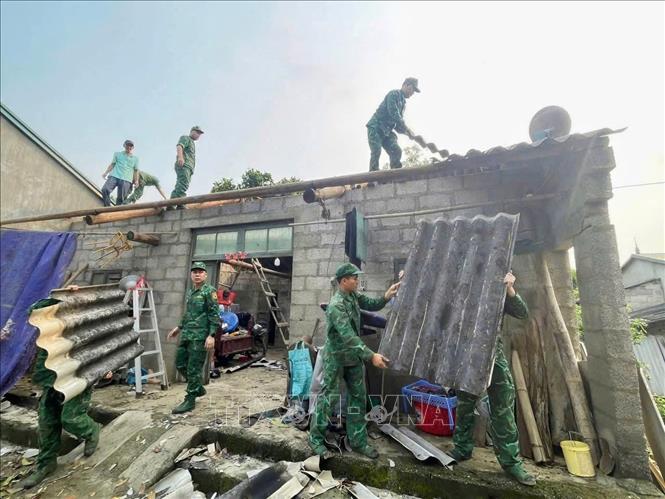 Bộ đội Biên phòng tỉnh Cao Bằng giúp người dân xã Phục Hòa khắc phục hậu quả thiên tai. Ảnh: TTXVN phát 
