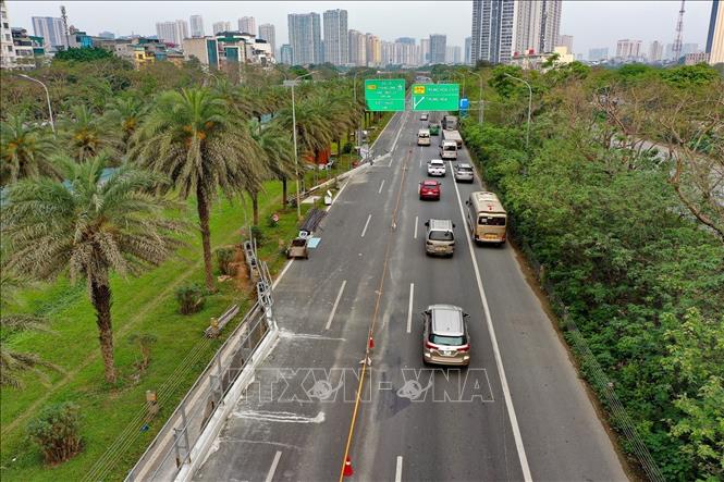 Các phương tiện xếp hàng di chuyển qua đoạn tuyến thi công. Ảnh: Trung Nguyên - TTXVN