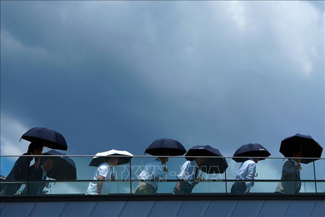 Người dân che ô tránh nắng nóng tại Osaka, Nhật Bản. Ảnh: THX/TTXVN