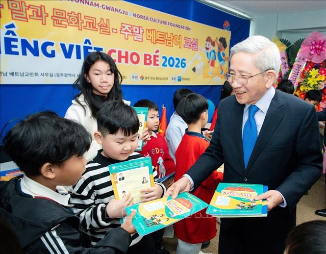 Giáo sư, Tiến sĩ Nguyễn Minh Thuyết tặng sách “Vui học tiếng Việt” (quyển 2) cho học sinh. Ảnh: Đức Thắng - PV TTXVN tại Hàn Quốc