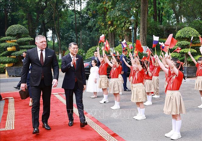 Thủ tướng Lê Minh Hưng và Thủ tướng Slovakia Robert Fico với thiếu nhi Hà Nội tại Lễ dón. Ảnh: Dương Giang - TTXVN