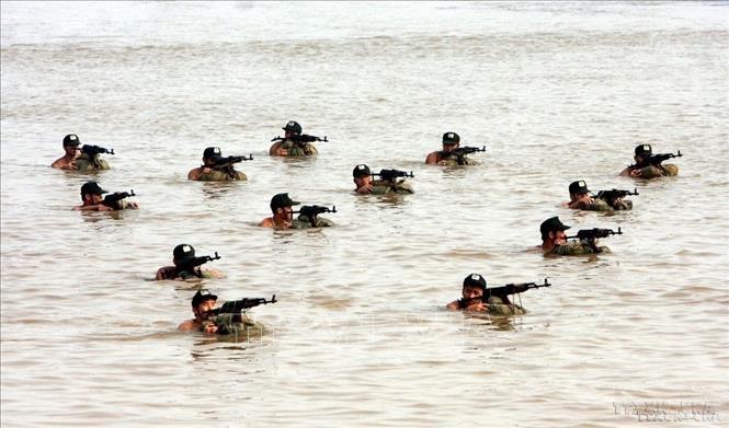 Lực lượng Cảnh sát cơ động vận động dưới sông, sẵn sàng chờ lệnh giải cứu con tin tại buổi diễn tập “Đánh bắt khủng bố, giải cứu con tin, rà phá bom mìn, cứu hộ, cứu nạn trên phương tiện giao thông đường thuỷ nội địa ” (2010). Ảnh: Trọng Đức - TTXVN