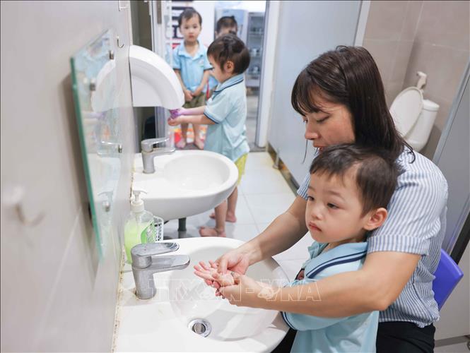 Các bé trường Mầm non Bà Triệu (phường Cửa Nam, Hà Nội) được chăm sóc, vệ sinh sạch sẽ trước mỗi bữa ăn bán trú. Ảnh: Thanh Tùng – TTXVN