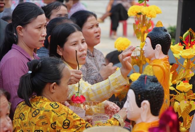 Đồng bào phật tử thực hiện nghi thức tắm tượng Phật. Ảnh: Nguyễn Hằng - TTXVN