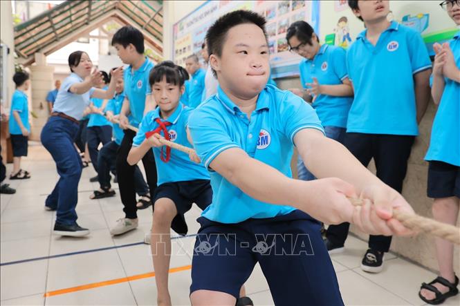 Những gương mặt quyết tâm trong phần thi kéo co đầy hấp dẫn. Ảnh: Lê Đông - TTXVN