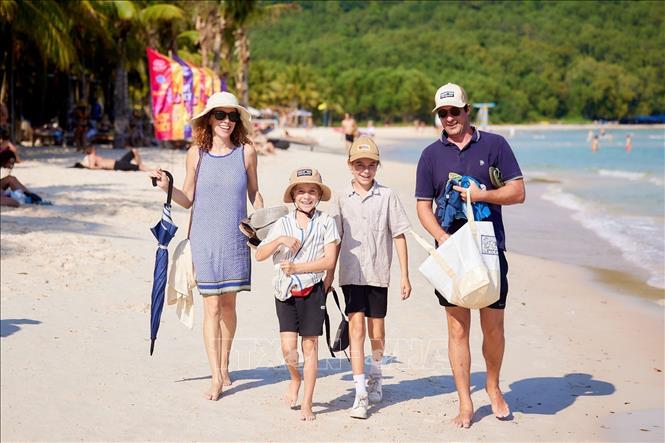 International tourists stroll on Bai Khem beach. VNA/Photo by courtesy