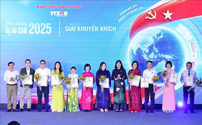 Nhà báo Phan Văn Đông, Phó giám đốc Trung tâm thông tin TTXVN khu vực phía Nam và nhà báo Vũ Mai Linh Hương, Trưởng Ban biên tập Tin đối ngoại TTXVN trao giải Khuyến khích cho các tác giả. Ảnh: Minh Đức – TTXVN