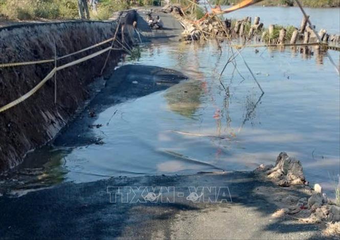 Hiện trường vụ sạt lở làm sụp lún tuyến đường giao thông trên địa bàn xã Cái Nước. Ảnh: TTXVN phát