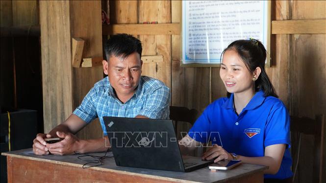 Thành viên Tổ công nghệ số cộng đồng thôn Vi Glơng, xã Kon Plông hướng dẫn người dân nộp hồ sơ thủ tục hành chính trực tuyến. Ảnh: Dư Toán - TTXVN