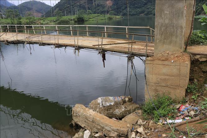Ảnh hưởng mưa lũ khiến 2 bên đầu cầu treo Khe Hóp bị xói lở, phá huỷ một phần nón chân khay trụ cầu. Ảnh: Anh Thùy - TTXVN