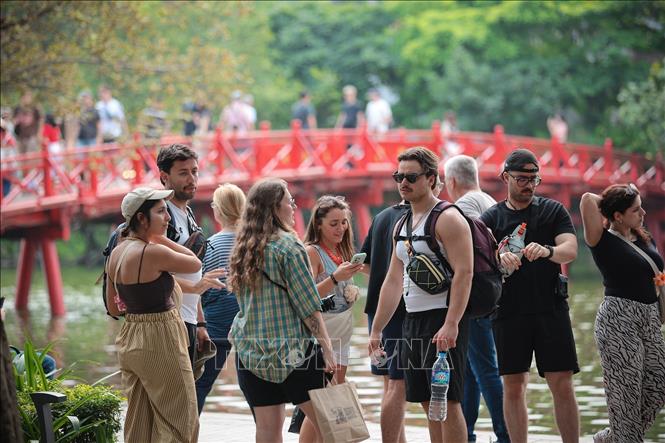 The Huc Bridge, leading to Ngoc Son Temple – a distinctive architectural symbol of Hanoi – is a popular check-in spot for international tourists. VNA Photo: Phạm Tuấn Anh