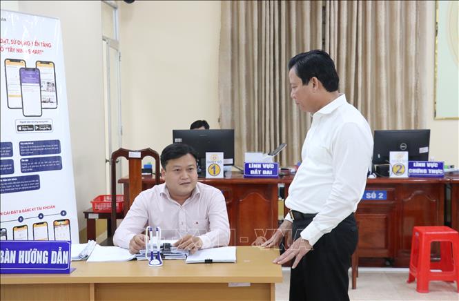 Phó Chủ tịch UBND tỉnh Tây Ninh Phạm Tấn Hòa (phải) kiểm tra công tác giải quyết thủ tục hành chính tại UBND xã Mỹ Yên, tỉnh Tây Ninh. Ảnh: Bùi Giang - TTXVN