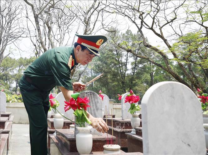 Đại tướng Phan Văn Giang, Phó Thủ tướng, Bộ trưởng Quốc phòng thắp hương trên phần mộ các Anh hùng, liệt sĩ. Ảnh: Thống Nhất – TTXVN