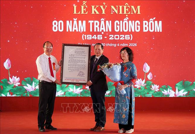 Bí thư Tỉnh ủy Cà Mau Nguyễn Hồ Hải trao hoa và Thư lưu niệm của Chủ tịch Hồ Chí Minh cho thân nhân gia đình cụ Cao Triều Phát. Ảnh: Huỳnh Anh - TTXVN