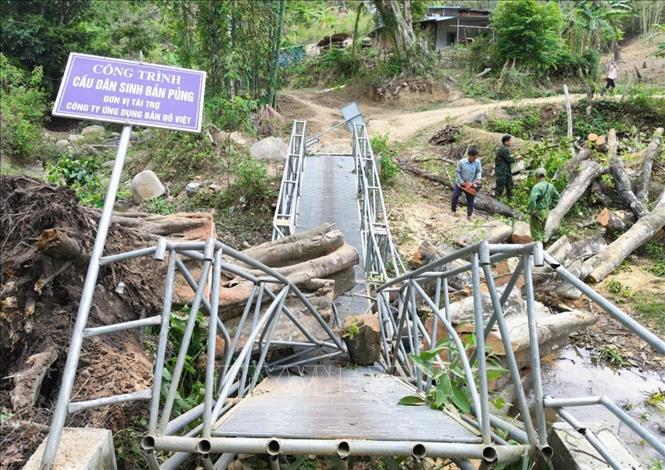 Dông lốc kèm gió giật mạnh đã gây đổ cây lớn, chắn lối đi và làm hư hỏng cầu dân sinh bản Pủng (xã Mường Típ, tỉnh Nghệ An). Ảnh: TTXVN phát