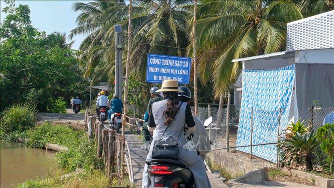 Biển cảnh báo nguy hiểm sạt lở để cảnh báo cho người đi đường ở ấp Phụng An, xã Nhơn Mỹ. Ảnh: Thanh Liêm - TTXVN