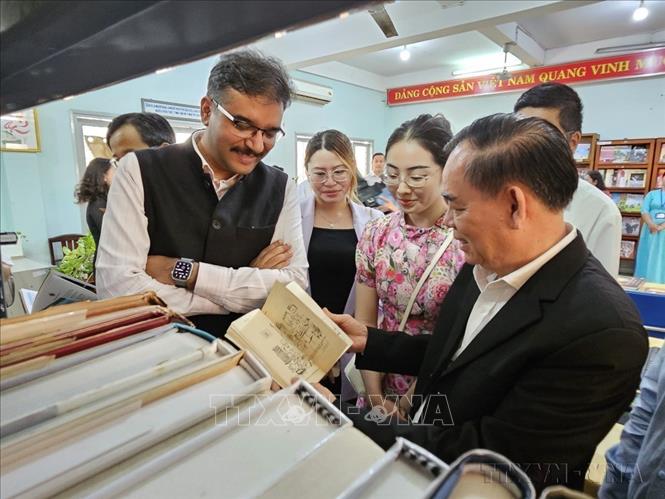 Lãnh đạo UBND tỉnh Bến Tre và Tổng lãnh sự Ấn Độ tại Thành phố Hồ Chí Minh tham khảo các tư liệu sách, ấn phẩm tại Lễ khánh thành “Góc Ấn Độ” tại thư viện Nguyễn Đình Chiểu (Bến Tre, 24/02/2025).  Ảnh: Chương Đài - TTXVN