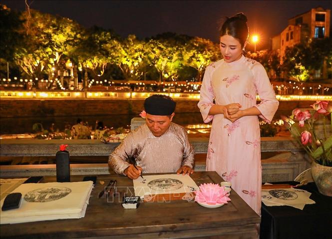 Hoạt động trải nghiệm in tranh và xin chữ thu hút người dân và du khách. Ảnh: Khánh Hoà - TTXVN