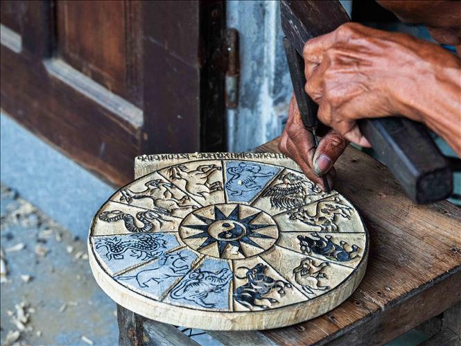 Sinh folk painting is created from patterned woodblock. Woodblock carving not only requires strength and perseverance but also memory and visual thinking; the craftsman must carve completely in reverse compared to the printed image; every line and pattern is 