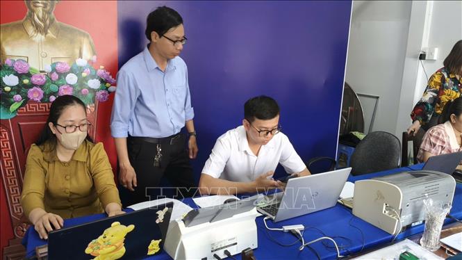 Cán bộ, công chức của Tổ hành chính lưu động phường Vĩnh Trạch, tỉnh Cà Mau chuẩn bị phương tiện để giải quyết thủ tục hành chính cho dân tại trụ sở khóm 4. Ảnh: Tuấn Kiệt - TTXVN