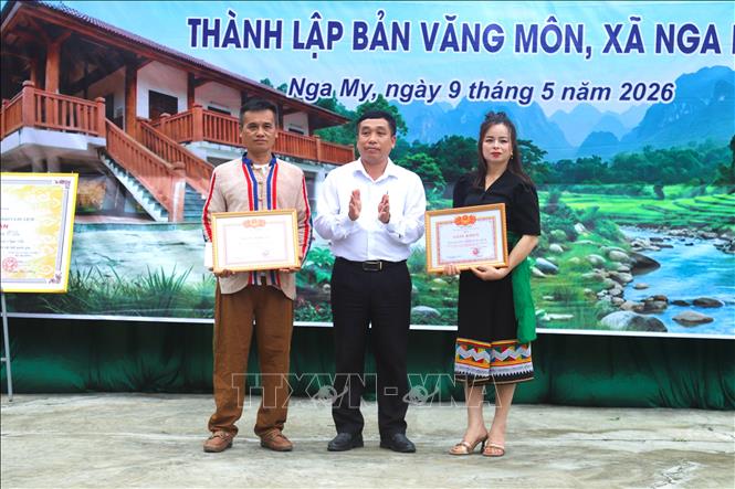 Ông Lô Khăm Kha, Chủ tịch UBND xã Nga My, tỉnh Nghệ An trao giấy khen cho 2 tập thể trong bản Văng Môn đã có thành tích xuất sắc trong việc bảo tồn những giá trị văn hóa của dân tộc Ơ Đu trong 20 năm qua. Ảnh: Xuân Tiến - TTXVN 