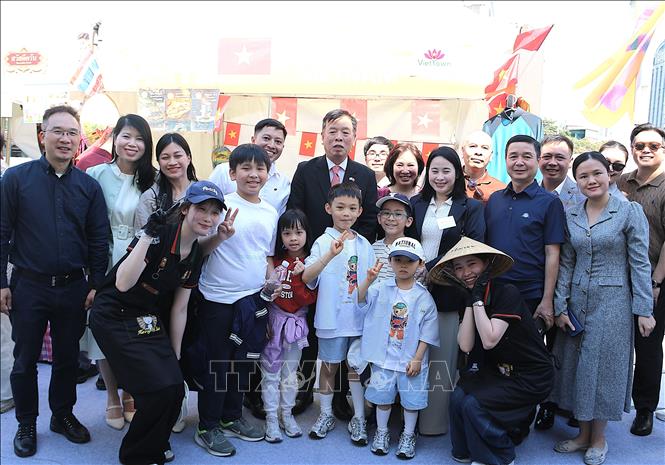 Đại sứ Vũ Hồ (Giữa) cùng các thành viên ĐSQ Việt Nam trước gian hàng Việt Nam. Ảnh: Khánh Vân - TTXVN tại Hàn Quốc