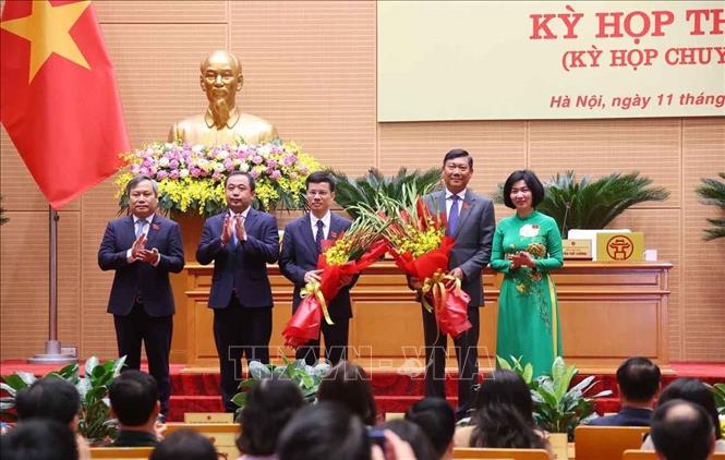 Lãnh đạo thành phố Hà Nội tặng hoa, chúc mừng tân Phó Chủ tịch UBND thành phố Hà Nội Đỗ Anh Tuấn và Bùi Duy Cường. Ảnh: Văn Điệp – TTXVN