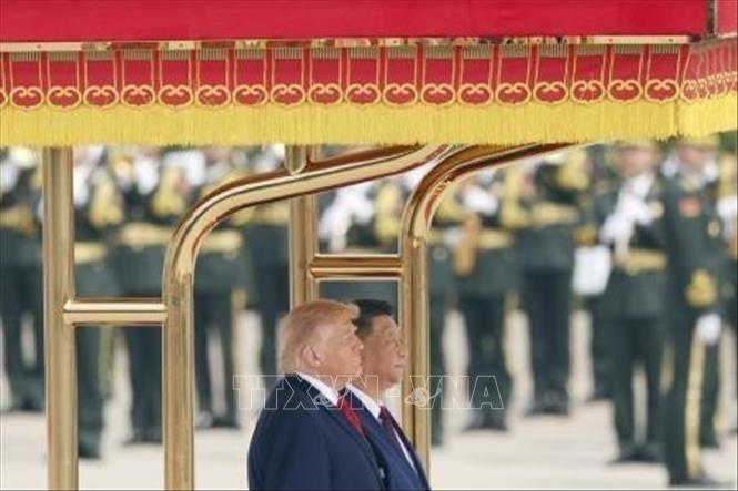 Chủ tịch Trung Quốc Tập Cận Bình (phía sau) và Tổng thống Mỹ Donald Trump tại lễ đón ở Đại lễ đường Nhân dân, thủ đô Bắc Kinh ngày 14/5/2026. Ảnh: Kyodo/TTXVN