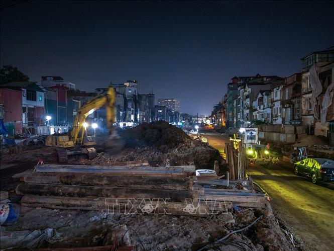 Nhiều thiết bị máy móc cỡ lớn hoạt động liên tục trong đêm để phục vụ thi công đường tuyến Vành đai 1. Ảnh: Lê Đông - TTXVN