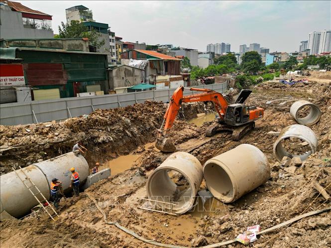 Đơn vị thi công đang triển khai lắp đặt hệ thống cống thoát nước trên tuyến dự án Vành đai 2,5. Ảnh: Lê Đông - TTXVN