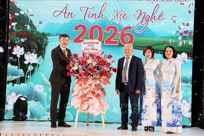 Đại sứ Dương Hoài Nam tặng lẵng hoa chúc mừng cho Chủ tịch Hội đồng hương Nghệ Tĩnh tại Cộng hoà Séc, ông Đinh Ngọc. Ảnh: Việt Thắng - PV TTXVN tại Séc