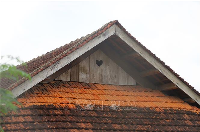 Họa tiết hình trái tim trên có kích thước đủ lớn trên khu vực vòm nóc để vừa là nơi lưu thông không khí, tạo khoảng sáng bên trong căn nhà sàn và ngăn cản nước mưa hắt vào. Ảnh: Xuân Tiến - TTXVN 