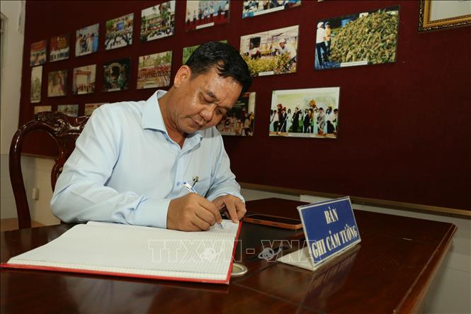 Ông Huỳnh Ngọc Nhã, Phó Bí thư Chuyên trách Đảng ủy, Bí thư Chi bộ cơ quan Đảng ủy UBND thành phố Cần Thơ ghi sổ cảm tưởng khi đến Đền thờ Bác Hồ. Ảnh: Duy Khương – TTXVN