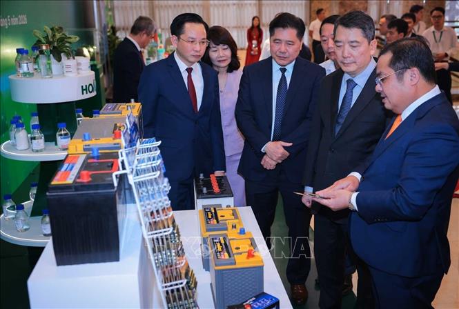 Thứ trưởng Bộ Tài chính Cao Anh Tuấn và lãnh đạo Tập đoàn Hoá chất Việt Nam tham quan triển lãm các sản phẩm của PINACO thuộc Tập đoàn Hoá chất Việt Nam. Ảnh: Hoàng Hiếu - TTXVN