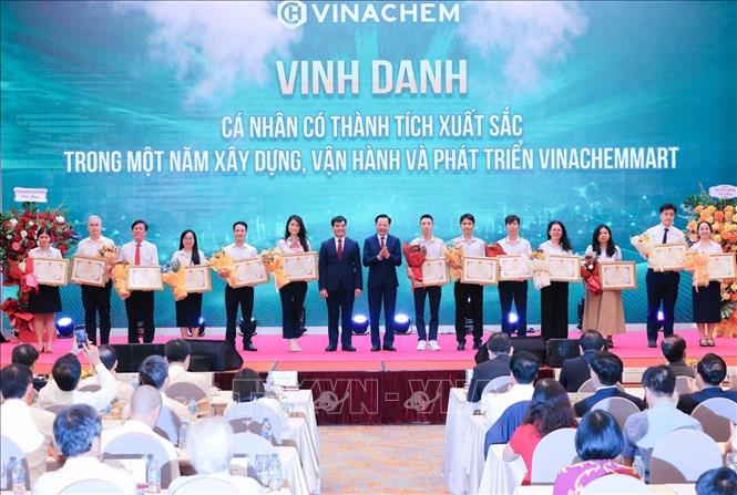 Chủ tịch Hội đồng thành viên Tập đoàn Hoá chất Việt Nam Phùng Quang Hiệp và Tổng giám đốc Tập đoàn Hoá chất Việt Nam Nguyễn Hữu Tú tặng Giấy khen và hoa cho các cá nhân đạt thành tích của Sàn thương mại điện tử Vinachemmart. Ảnh: Hoàng Hiếu - TTXVN