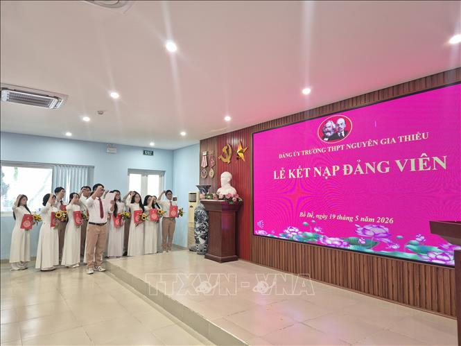 Các Đảng viên trẻ Đảng ủy Trường THPT Nguyễn Gia Thiều (phường Bồ Đề, Hà Nội) đọc lời tuyên thệ trước cờ Đảng và cờ Tổ quốc. Ảnh: Nguyễn Cúc-TTXVN