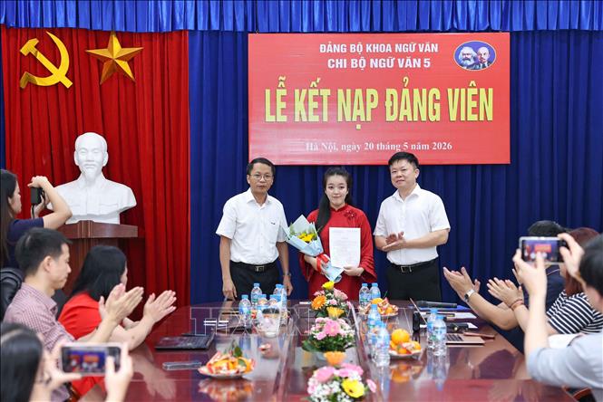 Lãnh đạo Đảng uỷ Khoa Ngữ văn tặng hoa chúc mừng đảng viên mới được kết nạp của Chi bộ Ngữ văn 5. Ảnh: Thanh Tùng - TTXVN 