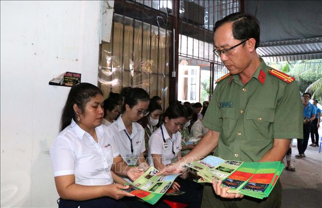 Phát tờ rơi tuyên truyền kiến thức về phòng chống ma tuý đến công nhân tại Chương trình. Ảnh: Thanh Hòa - TTXVN
